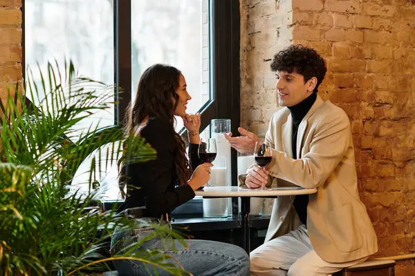 Two lovers celebrate their special day with wine and conversation in a charming venue. — Stock Photo
