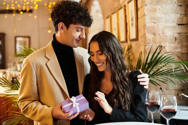 Young couple shares a joyful moment together while celebrating love and connection over dinner. — Stock Photo