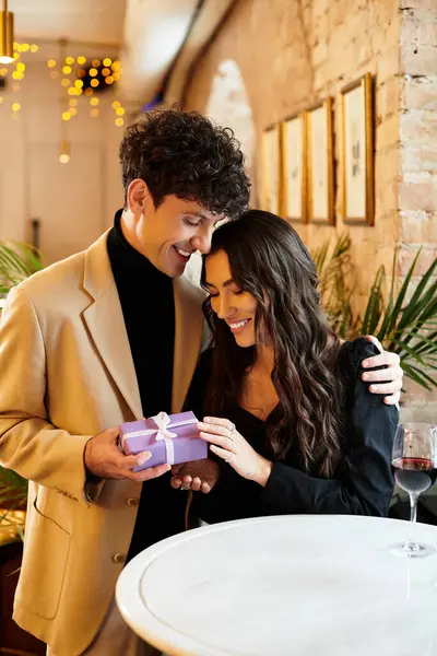 Young couple cherishes a sweet moment together on Valentines Day while enjoying dinner. — Stock Photo