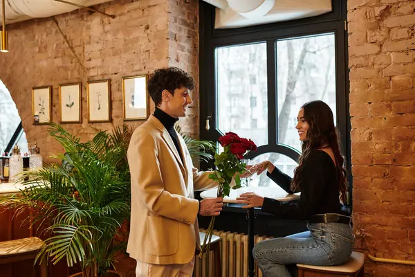 In a cozy restaurant setting, a young couple shares romantic moments while celebrating their love. — Stock Photo