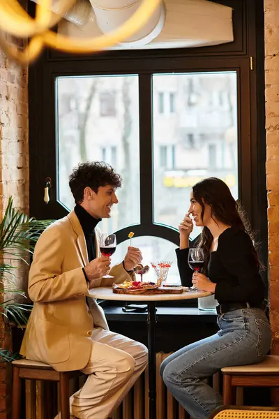 A young couple celebrates their love during Valentines Day at an intimate restaurant table. — Stock Photo