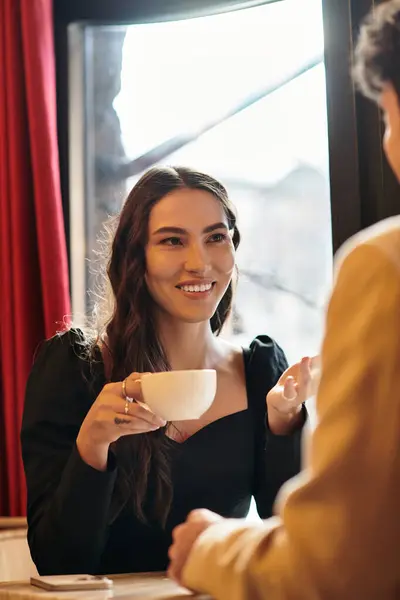 A young couple shares smiles and love over drinks in a cozy setting. — Stock Photo