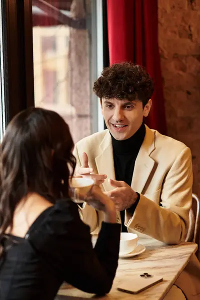 Celebrating love, a young couple shares a joyful moment, enjoying each others company while dining. — Stock Photo