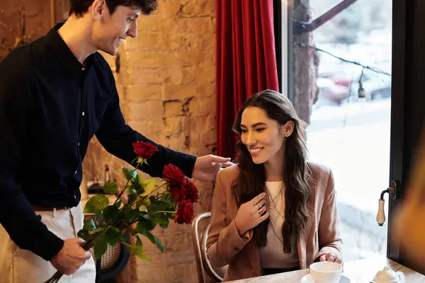 A happy couple shares a joyful moment amid roses, celebrating their love on Valentines Day. — Stock Photo