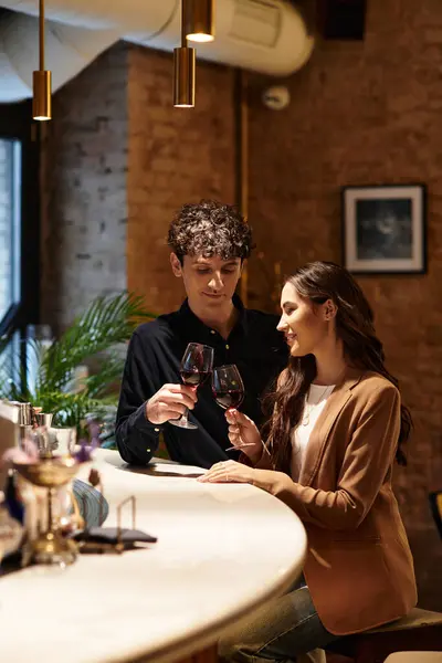 A young couple enjoys a special Valentines Day together over drinks, sharing laughter and love. — Stock Photo