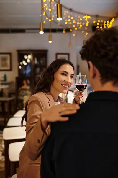 A couple enjoys a romantic dinner in a charming restaurant, toasting their love. — Stock Photo