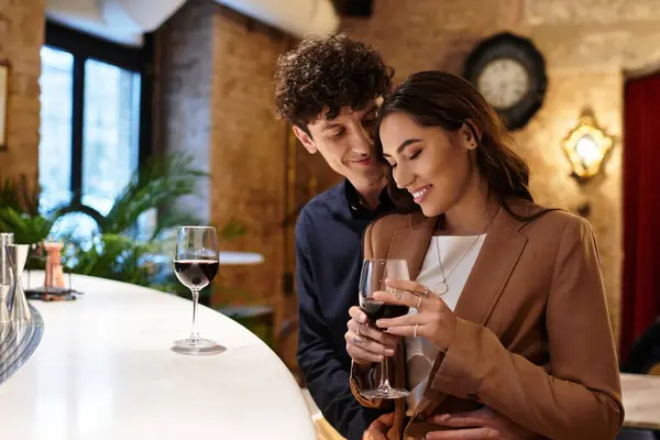 Young couple enjoys a special moment together, celebrating love in a cozy restaurant. — Stock Photo