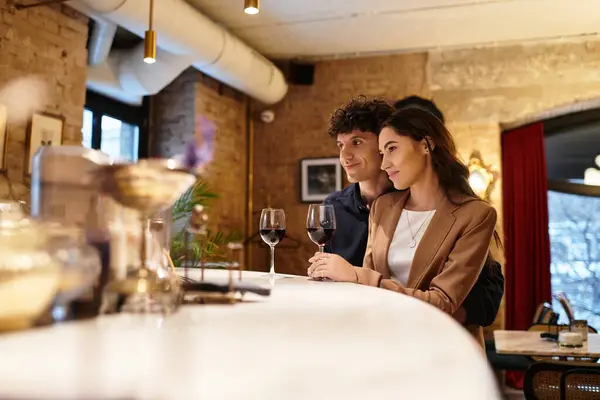 A young couple shares a cozy dinner, savoring wine and each others company. — Stock Photo