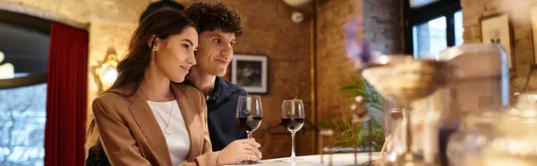 A beautiful couple celebrates their love during a cozy Valentines dinner with glasses of wine, banner — Stock Photo