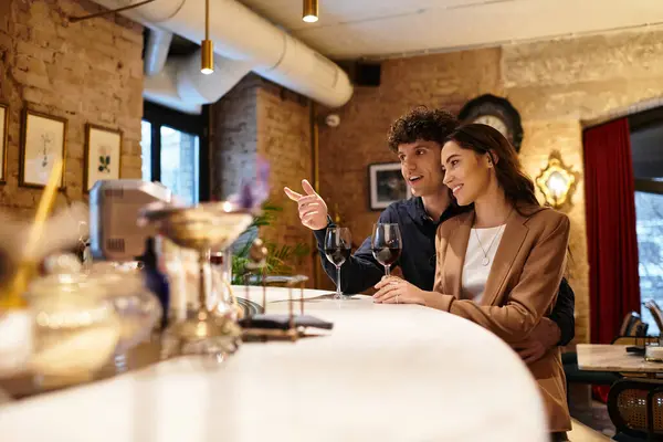 A young couple enjoys each others company while toasting with wine, celebrating love — Stock Photo