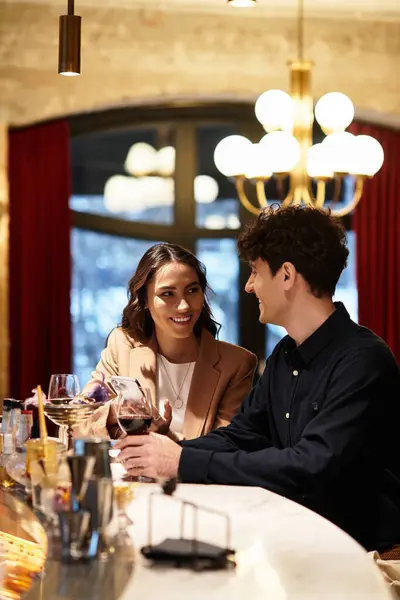 A lovely couple shares a cozy Valentines celebration at a romantic restaurant bar. — Stock Photo