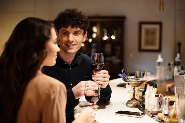 A young couple enjoys a romantic evening with wine, celebrating their love on Valentines Day. — Stock Photo