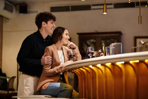 A beautiful young couple enjoys each others company while celebrating romance at a restaurant. — Stock Photo