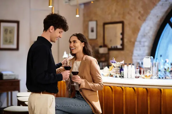 Two lovers share a special moment, celebrating their love with wine in an intimate restaurant. — Stock Photo