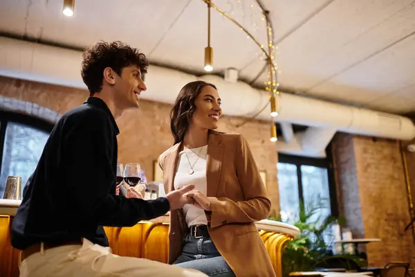 A couple enjoys a special moment together, sharing smiles and love in a charming restaurant. — Stock Photo