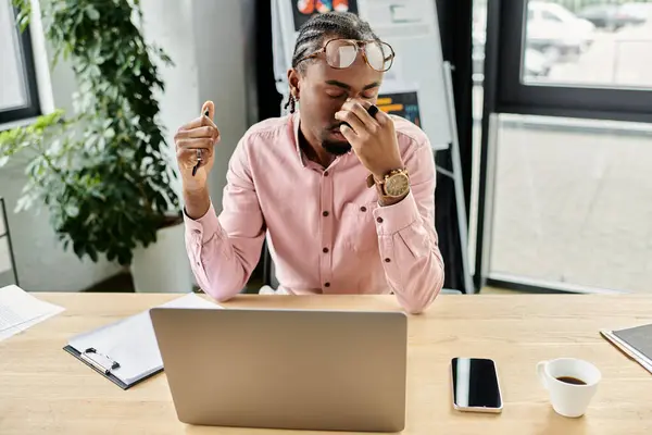 A professional young man works diligently at a sleek desk, immersed in his digital tasks. — Stock Photo