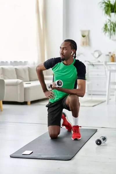 A focused young man stretches on a mat in an airy living room, dedicating time to fitness. — Stock Photo