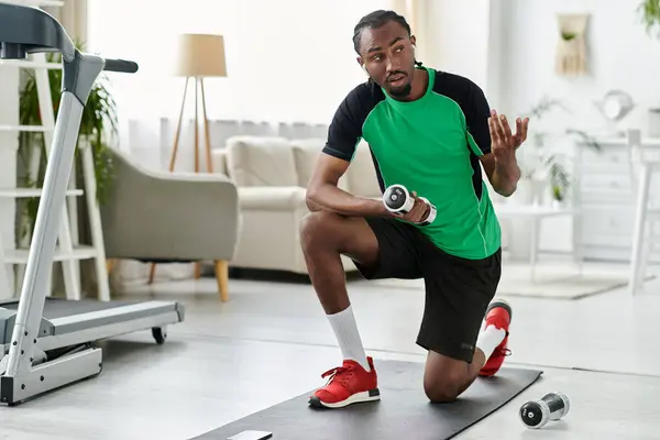 In a cozy indoor space, a young african american man exercises while balancing work and fitness. — Stock Photo