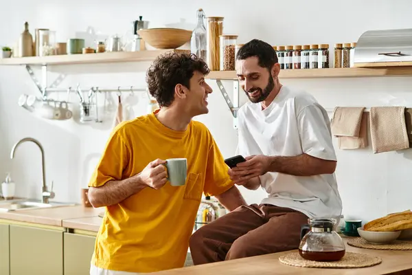 Two men share a joyful moment in their stylish apartment over casual conversation. — Stock Photo