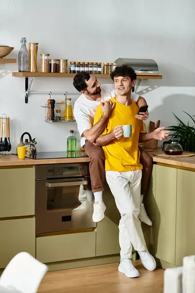 Two men share a light-hearted moment together in their stylish home, enjoying each others company. — Stock Photo