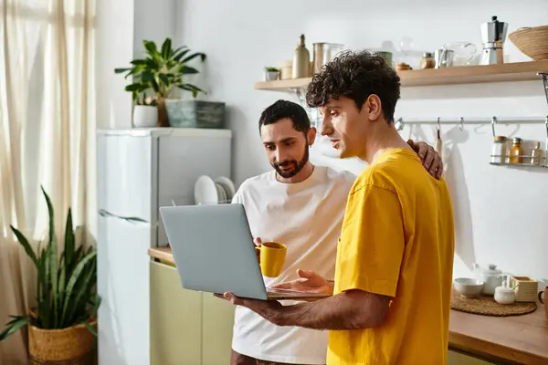 Two men share a joyful moment in their stylish home, enjoying each others company. — Stock Photo