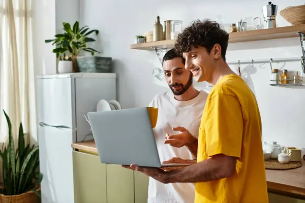 Two men in casual clothes share a delightful moment together in their modern home. — Stock Photo