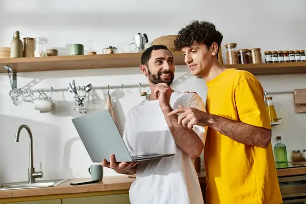 Two men share a joyful moment while exploring life together in their cozy home. — Stock Photo