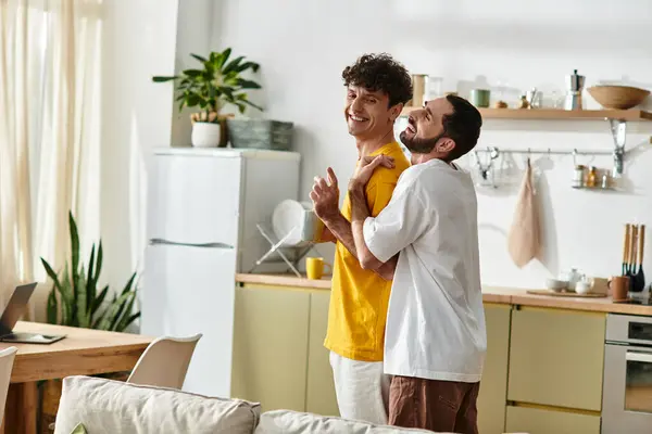 Two men share laughter and affection in their cozy, stylish home, enjoying each others company. — Stock Photo