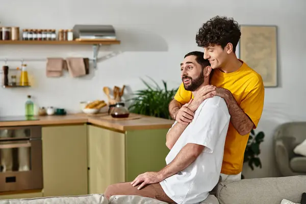 Two men share a joyful moment in their cozy apartment, embracing their deep bond. — Stock Photo