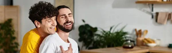 Two men share a joyful moment together, embracing and displaying their love in a stylish home, banner — Stock Photo