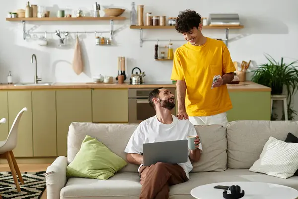 Two men share a joyful moment in their cozy modern home, celebrating their love and connection. — Stock Photo