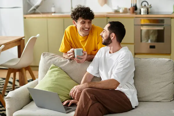 Two men share a joyful moment together while casually relaxing at home. — Stock Photo