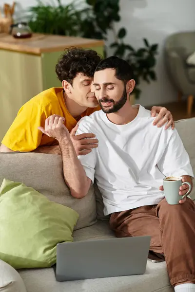 In a modern apartment, a loving gay couple relaxes together, deeply connected and engaged. — Stock Photo