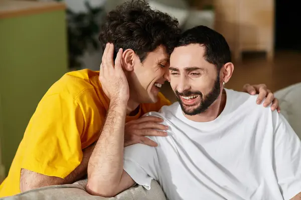 Two men share laughter and affection in their stylish home, celebrating their love together. — Stock Photo
