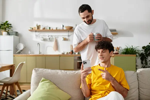 Two men share a joyful moment in their apartment, laughing and engaging with each other. — Stock Photo