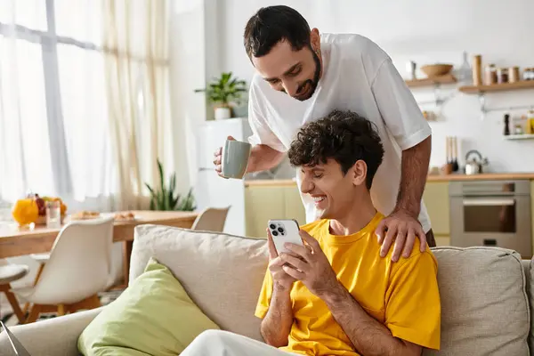 Two men enjoy each others company in their stylish apartment, showcasing love and happiness. — Stock Photo