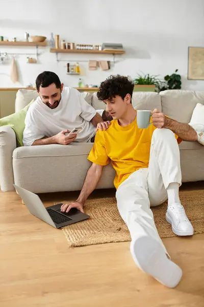 Two men share a warm moment in their stylish home, enjoying each others company and laughter. — Stock Photo