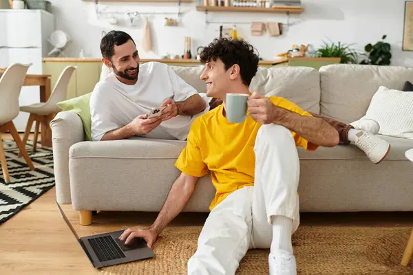 Two men share a joyful afternoon together in their cozy, stylish apartment. — Stock Photo