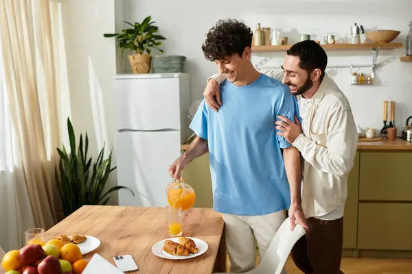 Two men enjoy a cozy breakfast together, sharing love and laughter in their stylish apartment. — Stock Photo