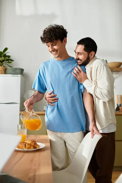 Two men share a joyful breakfast in their stylish apartment, celebrating their love. — Stock Photo