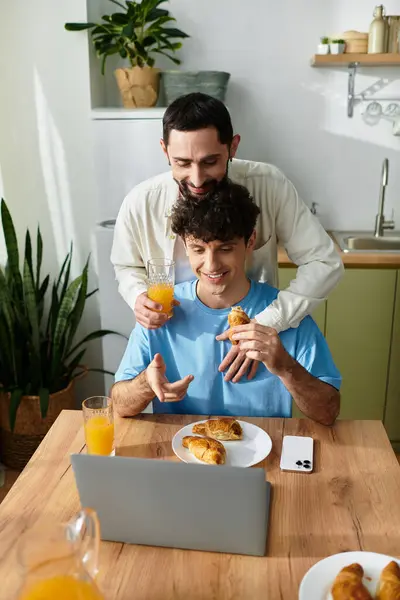 Two men enjoy a delightful breakfast together in their modern home, filled with love and laughter. — Stock Photo