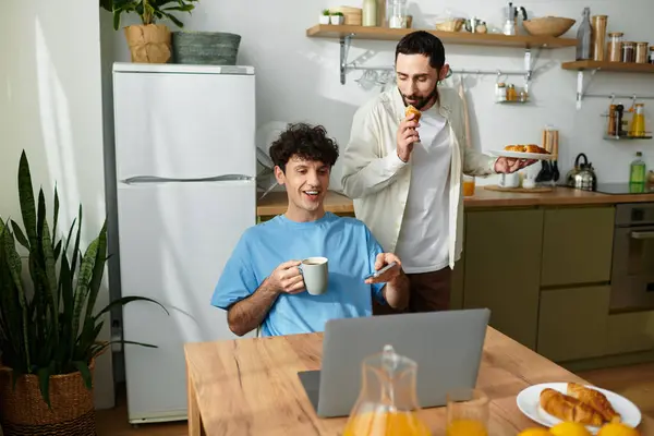 Two men enjoy breakfast together, sharing smiles and delicious food in their modern home. — Stock Photo