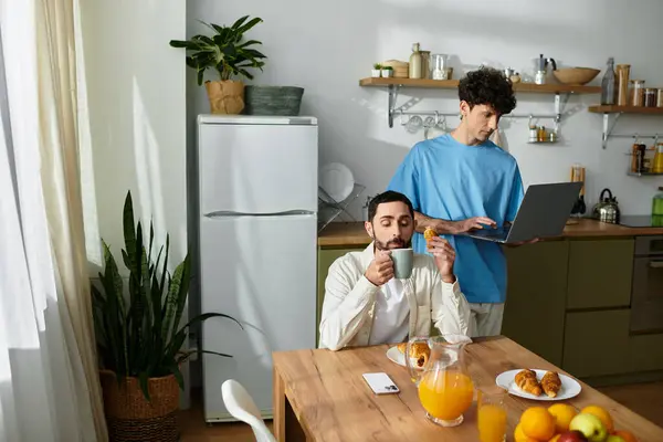 Two men share a cozy breakfast in their modern apartment, enjoying food and each others company. — Stock Photo