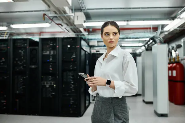 A skilled IT specialist in a white shirt oversees computer systems in a data center. — Stock Photo