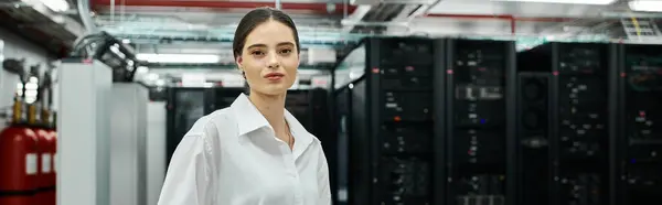 A woman in a white shirt works on server systems in a high-tech data center, banner — Stock Photo
