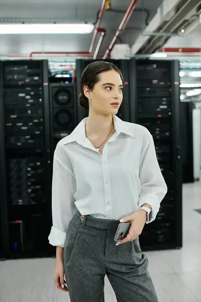 A skilled woman in a white shirt navigates a high-tech server room focusing on digital security. — Stock Photo