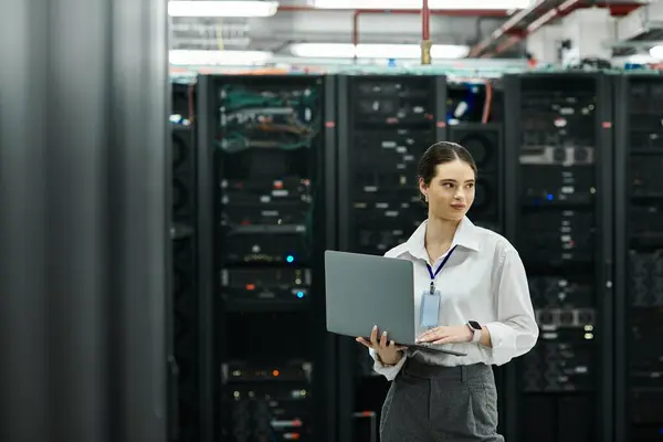 A skilled IT specialist works diligently in a high-tech server room, handling complex systems. — Stock Photo