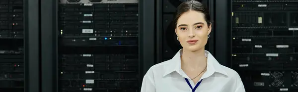 A skilled woman in a white shirt diligently works in a tech server room on digital security, banner — Stock Photo