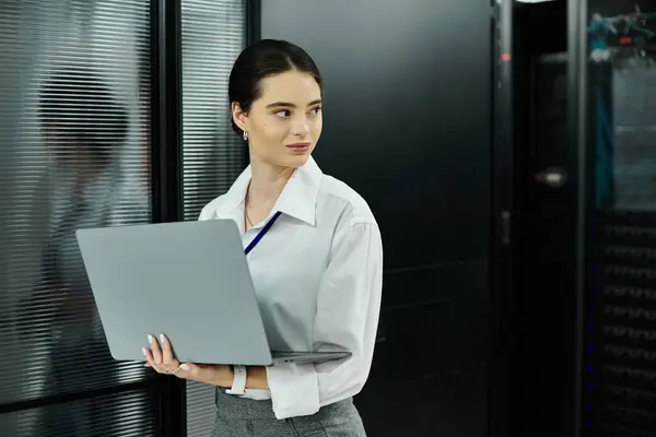 A skilled IT specialist manages computer systems while ensuring digital security in a server room. — Stock Photo