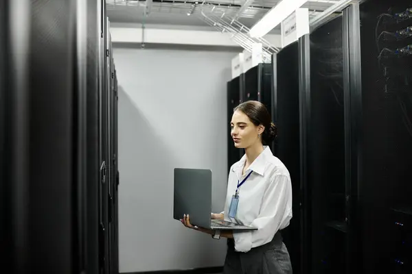A dedicated IT specialist in a white shirt manages computer systems in a data center. — Stock Photo